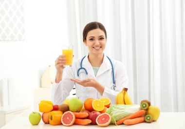 Female nutritionist with different fruits clipart