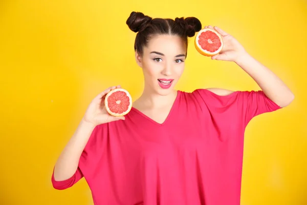 Schöne junge Frau mit Grapefruithälften — Stockfoto