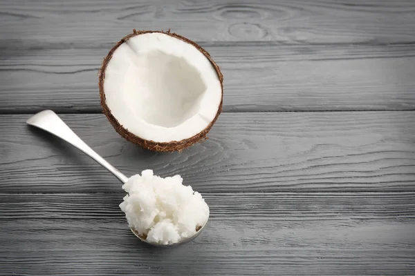 Metal spoon with fresh coconut oil — Stock Photo, Image