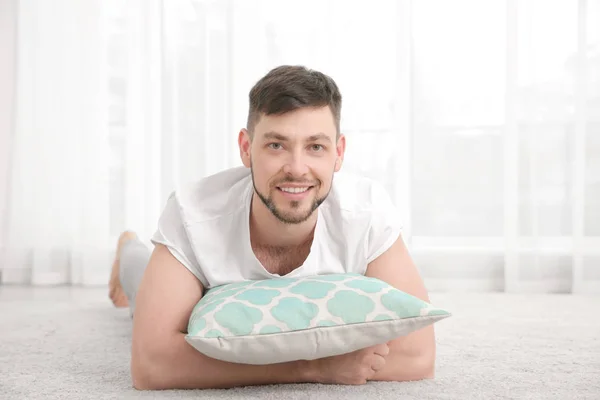 Man lying with pillow — Stock Photo, Image