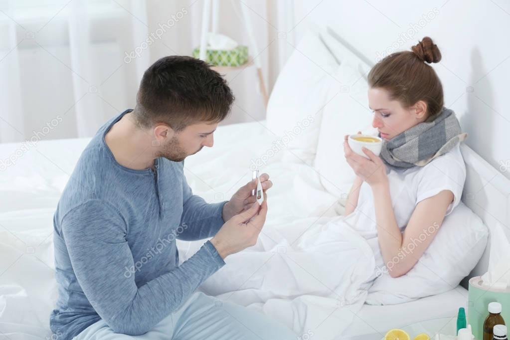 man taking care of ill woman