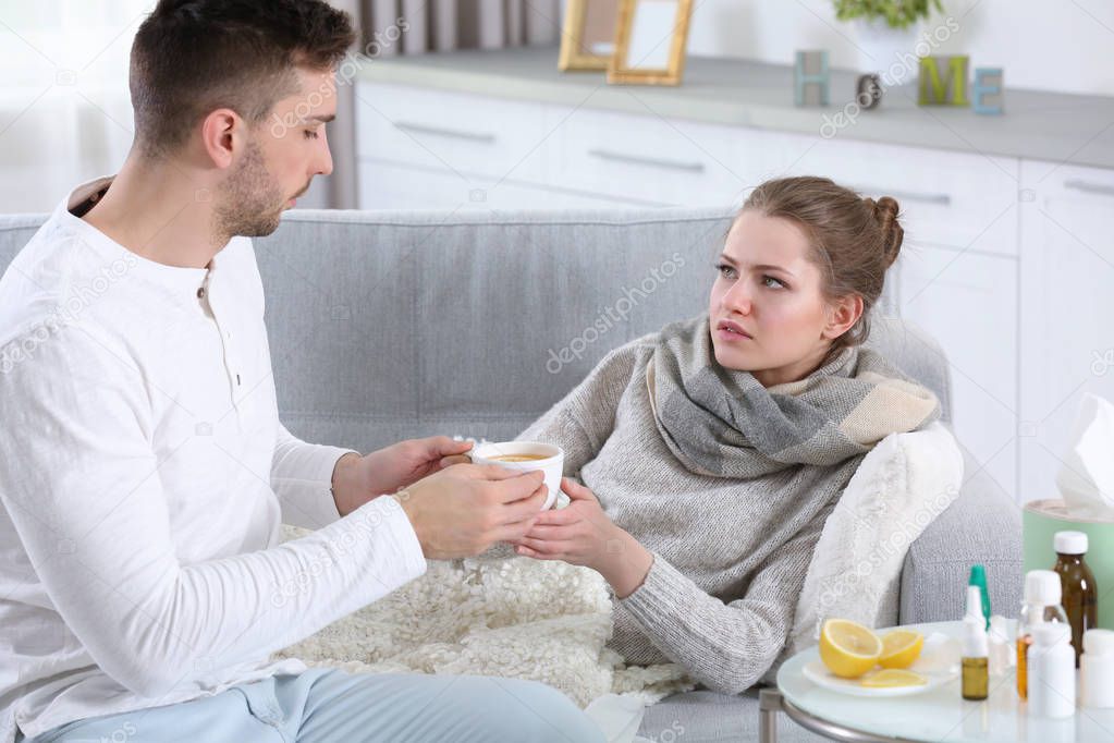 Man taking care of ill woman — Stock Photo © belchonock