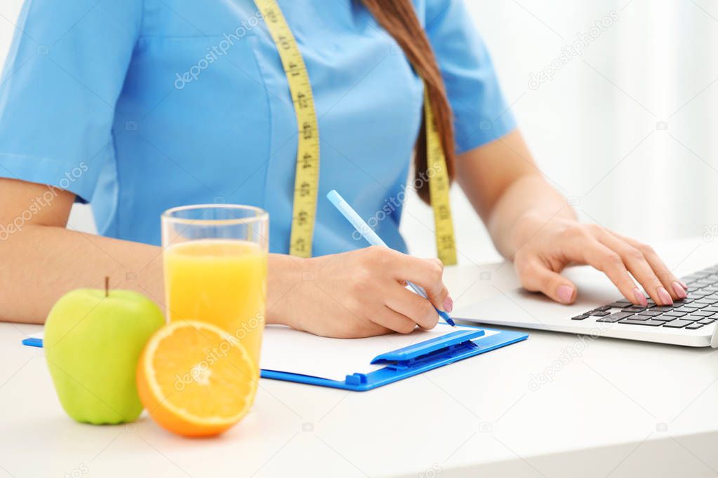 Nutritionist doctor writing diet plan 