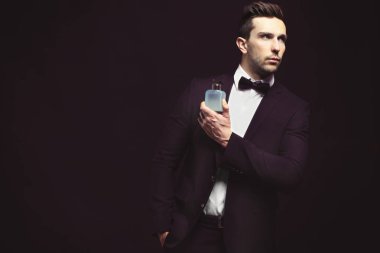 Parfüm kullanan yakışıklı genç adam. 