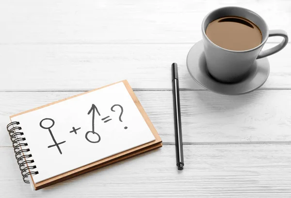 Male and female symbols near cup of coffee — Stock Photo, Image