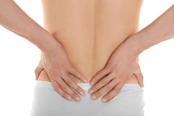 Young man suffering from back pain on white background, closeup — Stock Photo, Image