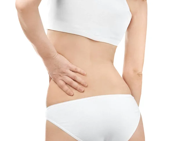 Young woman suffering from back pain on white background, closeup — Stock Photo, Image