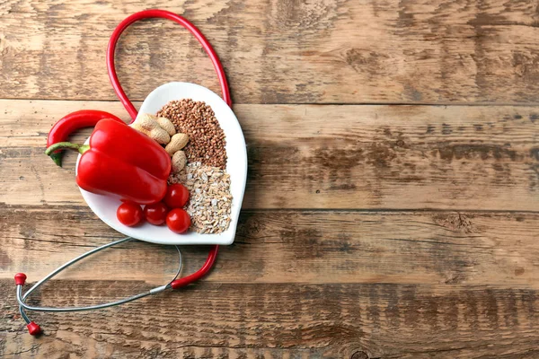Healthy food in heart shaped plate — Stock Photo, Image