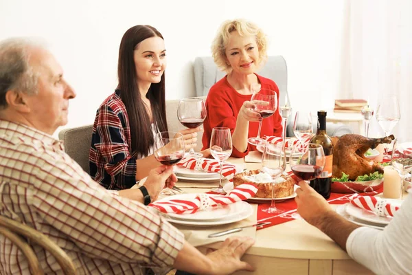 Happy family having Thanksgiving dinner in living room