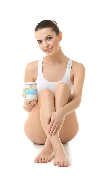 Young woman with jar of coconut oil — Stock Photo, Image