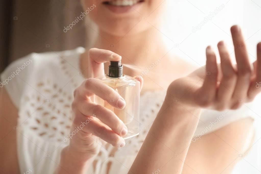 Woman with bottle of perfume