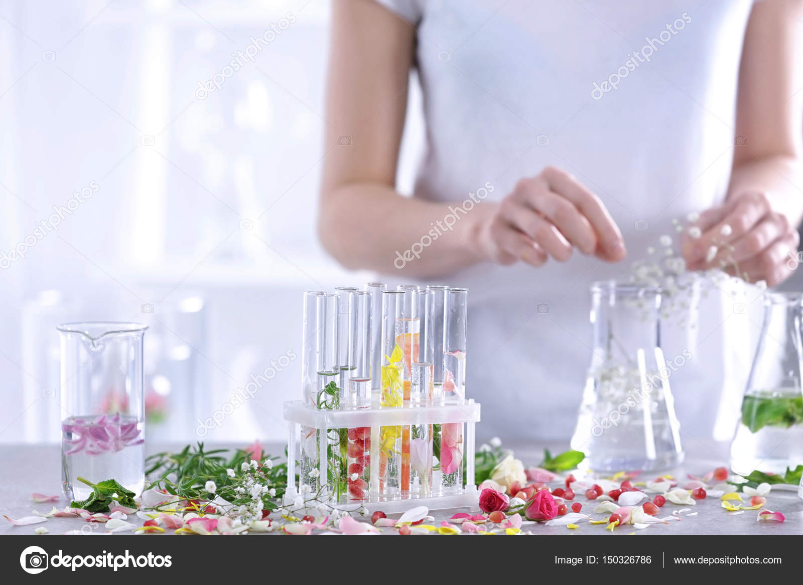Woman mixing perfume samples Stock Photo by ©belchonock 150326786