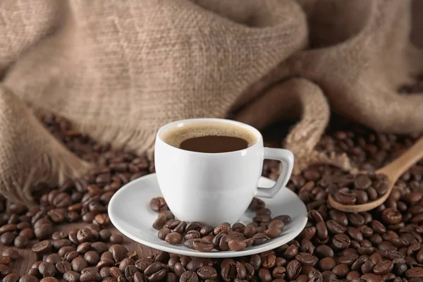 Cup of coffee with roasted beans — Stock Photo, Image