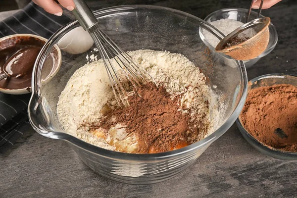 Woman preparing dough for brownies