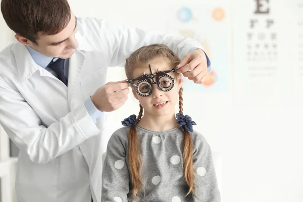 Oftalmologista examinando olhos de menina na clínica — Fotografia de Stock