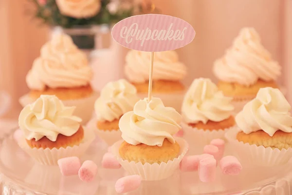 Stand with tasty cupcakes on table, closeup — Stock Photo, Image