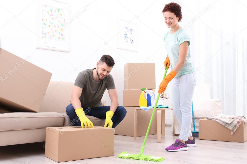 young couple cleaning home 