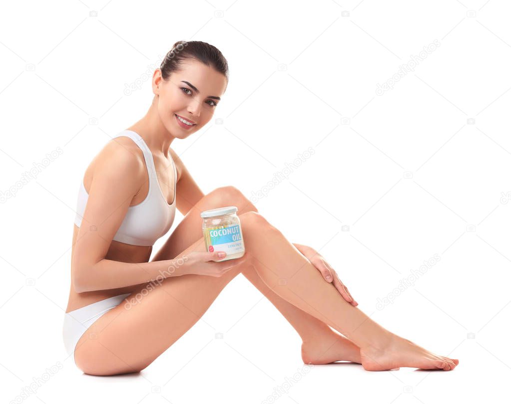 young woman with jar of coconut oil  