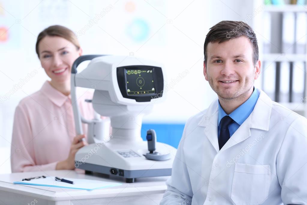 Male doctor examining adult female patient