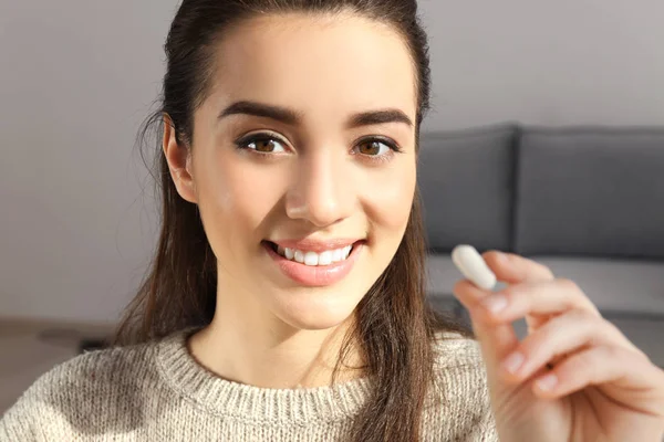 Beautiful young woman with pill — Stock Photo, Image