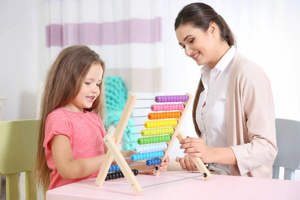 Young woman teacher and little girl on private lesson — Stock Photo, Image