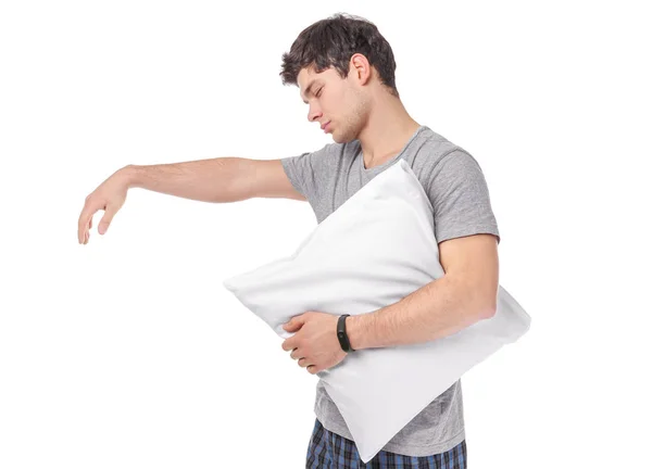 Молодой сонный мужчина с подушкой, страдающий сомнамбулизмом на белом фоне — стоковое фото