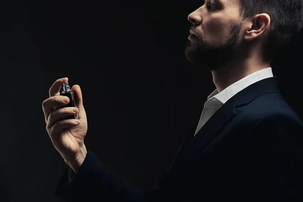 Handsome young man using perfume — Stock Photo, Image