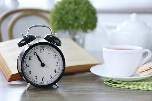 Retro alarm clock on lunch table — Stock Photo, Image