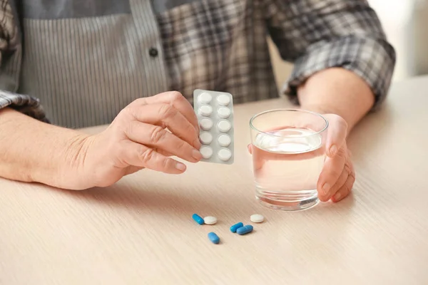 Elderly woman with pills — Stock Photo, Image