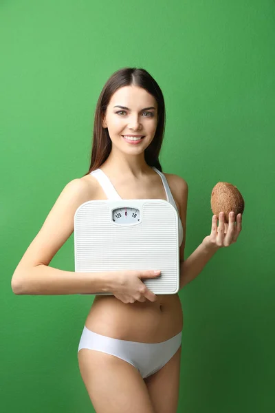 Beautiful young woman with scales — Stock Photo, Image