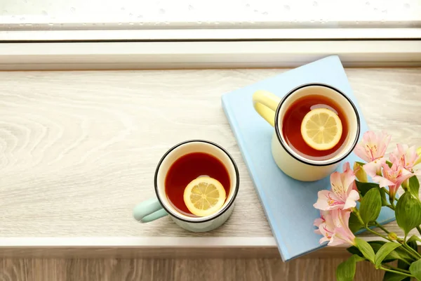 Composition avec tasses de thé sur le rebord de la fenêtre — Photo