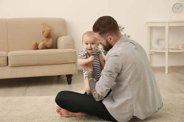Tatuerade ungersven leker med söta lilla bebis hemma — Stockfoto