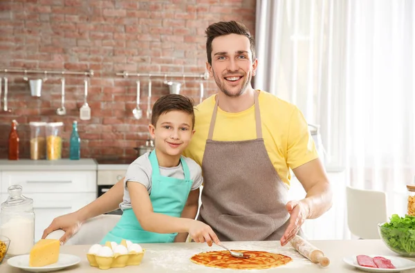 Dad and son cooking at home