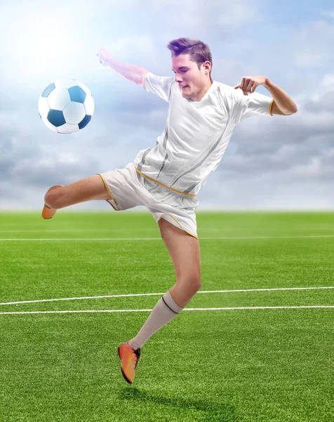 Professional sportsman playing football at stadium — Stock Photo, Image