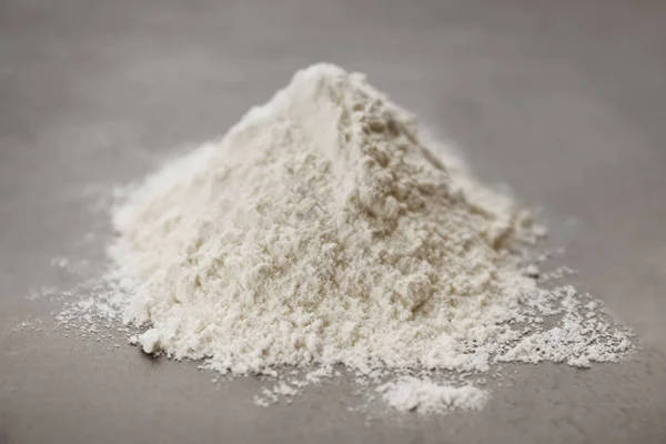 Heap of flour on grey table — Stock Photo, Image