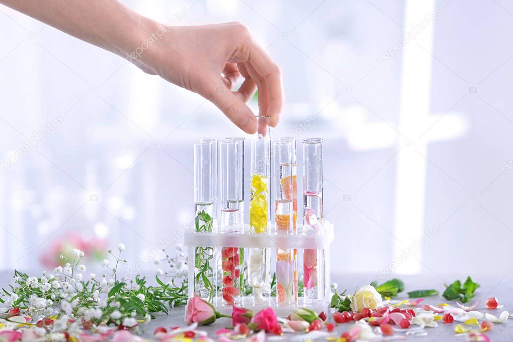 Woman mixing perfume samples