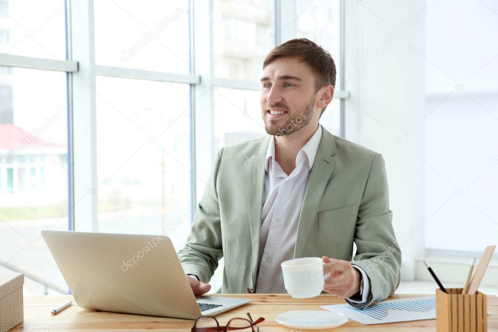 Handsome young man with laptop 