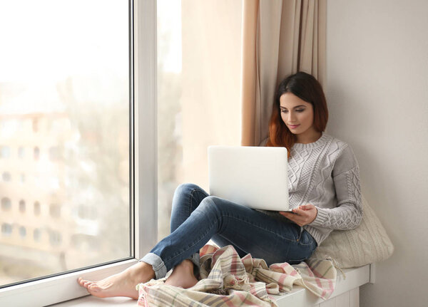 Beautiful young woman with laptop 