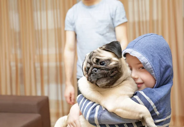 Little boy with pug dog at home — Stock Photo, Image