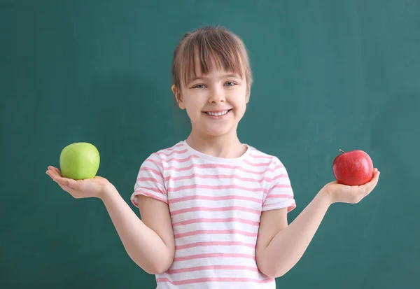Happy schoolgirl with apples — Stock Photo, Image