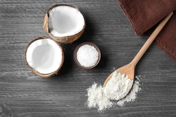 Coconut and flour in wooden spoon — Stock Photo, Image