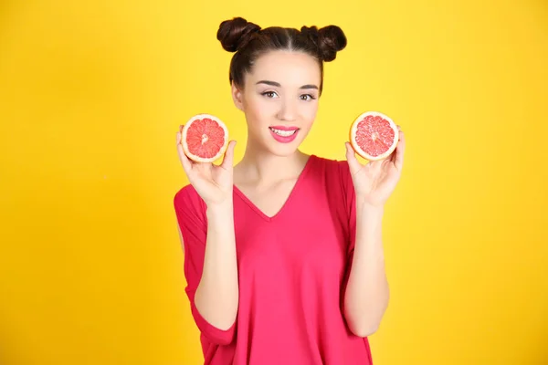 Красива молода жінка з половинками грейпфрута — стокове фото