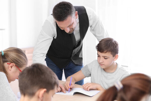 Male teacher conducting lesson in classroom