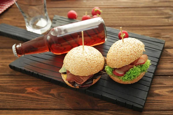 Tasty sandwiches and bottle — Stock Photo, Image