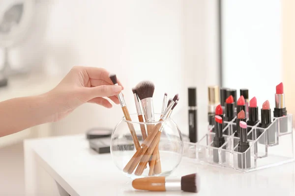 Professional makeup artist taking brush — Stock Photo, Image