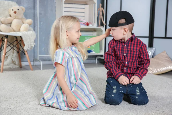 Leuke grappige kinderen zitten op tapijt thuis — Stockfoto
