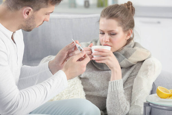 man taking care of ill woman