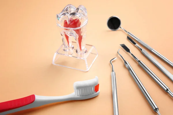 Toothbrush, dental instruments and plastic tooth — Stock Photo, Image