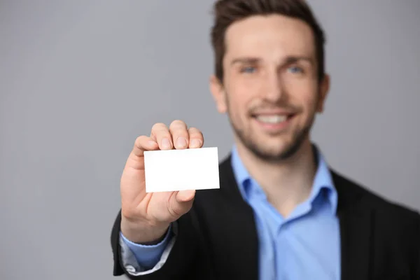 Handsome young man with business card — Stock Photo, Image