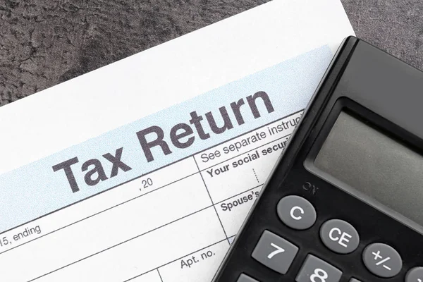 Tax return form and calculator Stock Photo